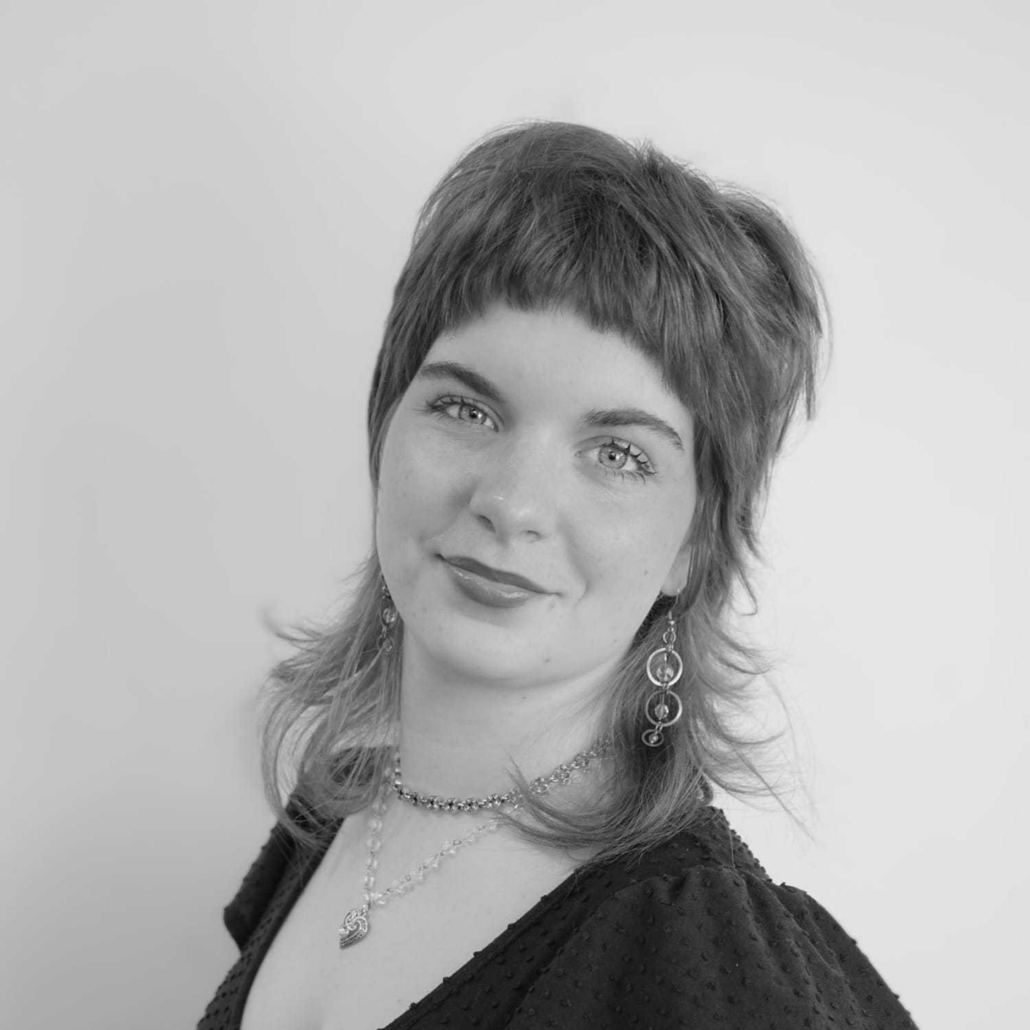 Portrait of Tyler, a professional stylist at CONFETTI CROWN. a salon+spa, showcasing their expertise and style.