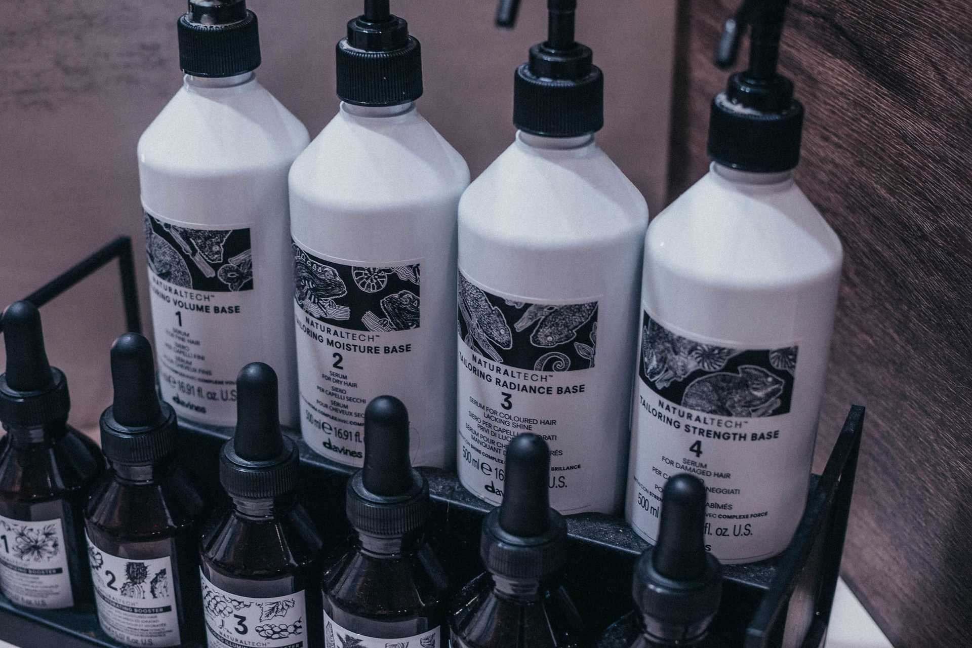 Hair care products in numbered bottles on a shelf.