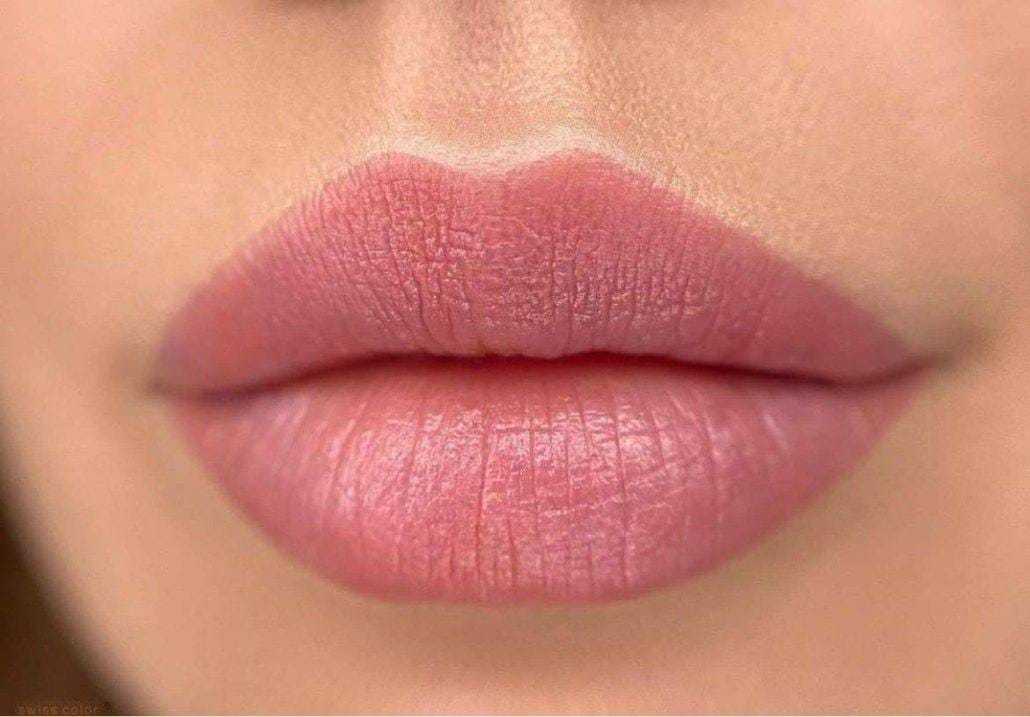 Close-up of well-moisturized pink lips, showing texture and natural color.
