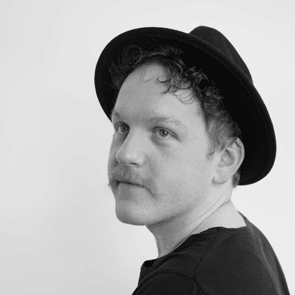 Portrait of Erik, a professional stylist at CONFETTI CROWN. a salon+spa, showcasing their expertise and style.