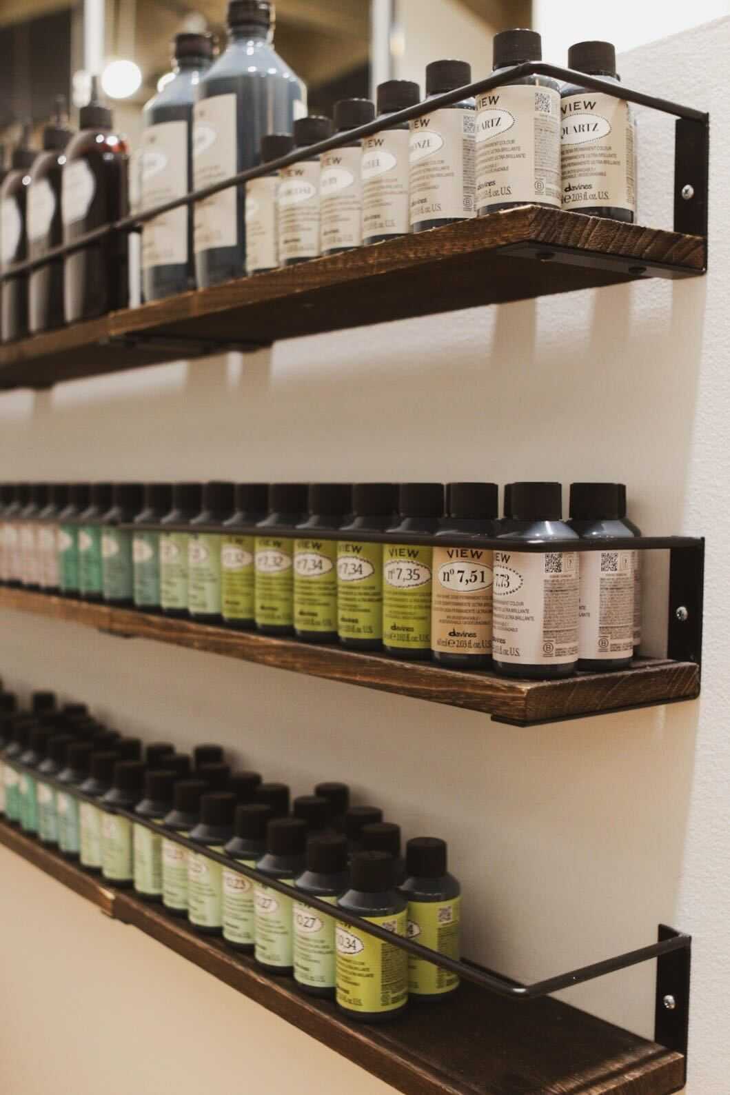 Shelves filled with various paint bottles arranged in a neatly organized display.