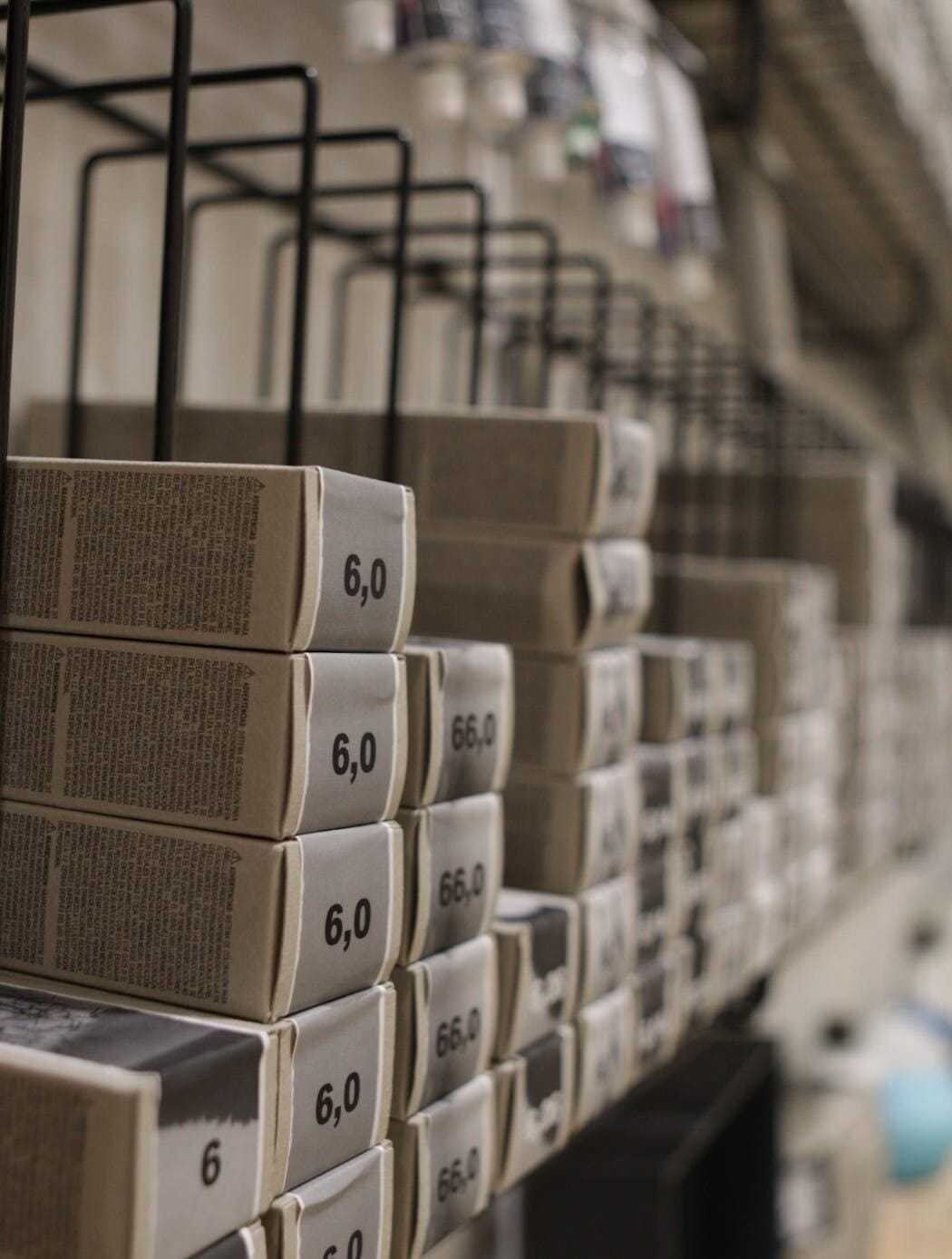 Boxes labeled "6.0" neatly stacked on a shelf in a storage or warehouse setting.