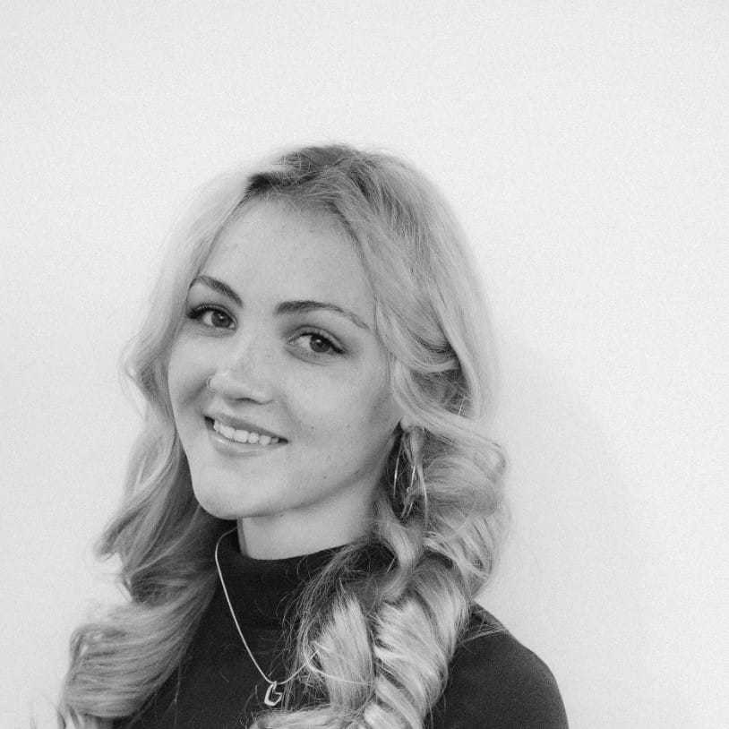 Portrait of Ella, a professional stylist at CONFETTI CROWN. a salon+spa, showcasing their expertise and style.